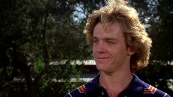 Movie still from “Caddyshack” (1980), directed by Harold Ramis – A person wearing a blue and white shirt; Close Up shot, Low angle