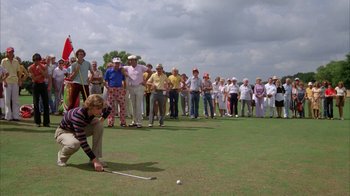 Movie still from “Caddyshack” (1980), directed by Harold Ramis – A group of people standing around a golf course; Wide shot, High angle