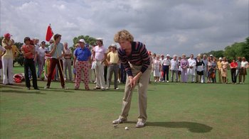 Movie still from “Caddyshack” (1980), directed by Harold Ramis – An older woman is playing a game of golf; Wide shot, High angle