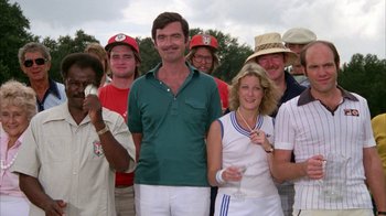 Movie still from “Caddyshack” (1980), directed by Harold Ramis – A group of people standing next to each other on a field; Medium shot, Low angle