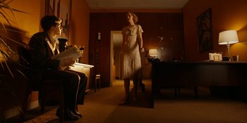 Movie still from “Café Society” (2016), directed by Woody Allen – A woman standing in front of a mirror in a room; Wide shot, Low angle