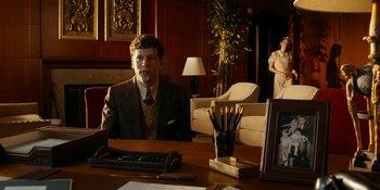 Movie still from “Café Society” (2016), directed by Woody Allen – A man sitting at a desk in front of a woman; Medium shot, Over the shoulder angle
