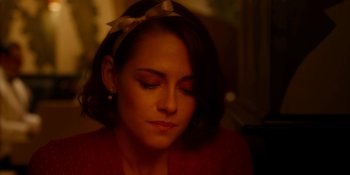 Movie still from “Café Society” (2016), directed by Woody Allen – A person wearing a headband; Close Up shot, High angle