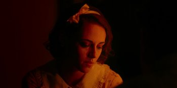 Movie still from “Café Society” (2016), directed by Woody Allen – A woman with a bow in her hair looking down; Close Up shot, High angle