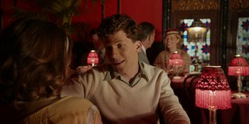Movie still from “Café Society” (2016), directed by Woody Allen – A man sitting in front of a woman at a table; Medium shot, Over the shoulder angle