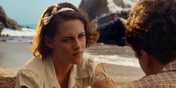 Movie still from “Café Society” (2016), directed by Woody Allen – A person sitting on the beach; Close Up shot, Over the shoulder angle