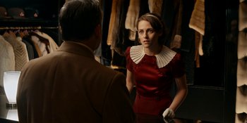 Movie still from “Café Society” (2016), directed by Woody Allen – A woman in a red dress talking to a man in a suit; Medium shot, Over the shoulder angle