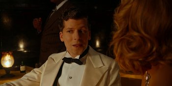 Movie still from “Café Society” (2016), directed by Woody Allen – A man in a white suit and a black bow tie; Close Up shot, Over the shoulder angle