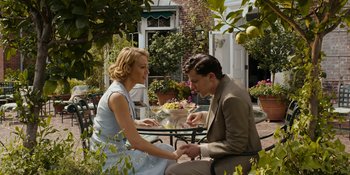 Movie still from “Café Society” (2016), directed by Woody Allen – A man and a woman sitting at a table outside; Medium shot, High angle