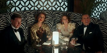 Movie still from “Café Society” (2016), directed by Woody Allen – Two women sitting at a table with wine glasses; Medium shot, Over the shoulder angle
