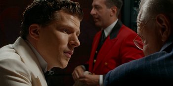 Movie still from “Café Society” (2016), directed by Woody Allen – A man in a red jacket and a man in a black suit; Close Up shot, Over the shoulder angle