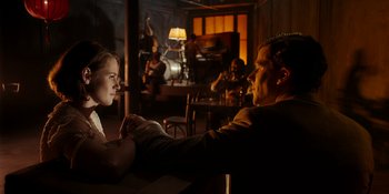 Movie still from “Café Society” (2016), directed by Woody Allen – A man and a woman sitting at a table in front of each other; Medium shot, Over the shoulder angle