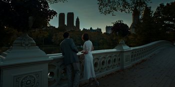 Movie still from “Café Society” (2016), directed by Woody Allen – A man and a woman standing next to each other on a bridge; Wide shot, High angle