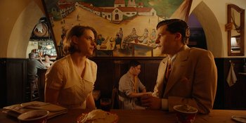 Movie still from “Café Society” (2016), directed by Woody Allen – A man and a woman sitting at a table; Medium shot, Over the shoulder angle