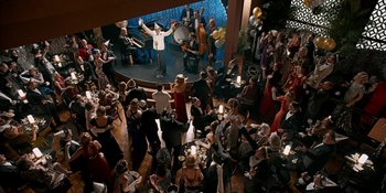 Movie still from “Café Society” (2016), directed by Woody Allen – An overhead view of a crowd of people at a party; Extreme Wide shot, High angle