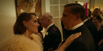 Movie still from “Café Society” (2016), directed by Woody Allen – A man and a woman are talking to each other at an event; Close Up shot, Over the shoulder angle