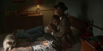 Movie still from “Fargo” (2014), created by Noah Hawley – An older man sitting on a bed with a young boy; Medium shot, High angle