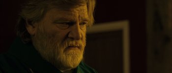 Movie still from “Calvary” (2014), directed by John Michael McDonagh – An old man with a beard and a green shirt; Close Up shot, Over the shoulder angle