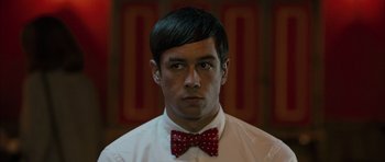 Movie still from “Calvary” (2014), directed by John Michael McDonagh – A man wearing a red bow tie and a white shirt; Close Up shot, Over the shoulder angle