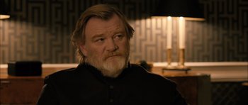 Movie still from “Calvary” (2014), directed by John Michael McDonagh – An older man with a beard and mustache; Close Up shot, Over the shoulder angle