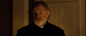 Movie still from “Calvary” (2014), directed by John Michael McDonagh – An old man with a beard and a white shirt; Close Up shot, Low angle