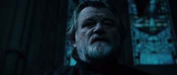 Movie still from “Calvary” (2014), directed by John Michael McDonagh – An old man with a beard is looking at the camera; Close Up shot, Low angle