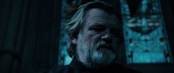 Movie still from “Calvary” (2014), directed by John Michael McDonagh – An old man with a beard and a black shirt; Close Up shot, Low angle
