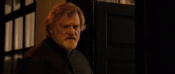 Movie still from “Calvary” (2014), directed by John Michael McDonagh – An old man with a beard and a mustache; Close Up shot, Over the shoulder angle