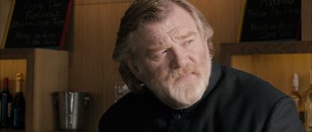 Movie still from “Calvary” (2014), directed by John Michael McDonagh – An older man with long hair and a goatee; Close Up shot, Over the shoulder angle