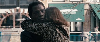 Movie still from “Calvary” (2014), directed by John Michael McDonagh – A man and a woman hugging each other outside; Close Up shot, High angle