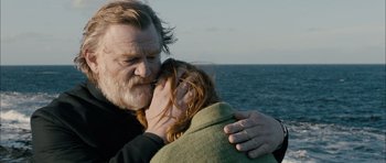 Movie still from “Calvary” (2014), directed by John Michael McDonagh – A man and a woman kissing near the ocean; Close Up shot, Over the shoulder angle