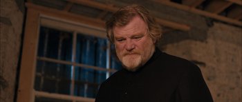 Movie still from “Calvary” (2014), directed by John Michael McDonagh – A man with a beard and a black shirt; Close Up shot, Low angle