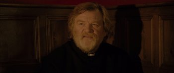 Movie still from “Calvary” (2014), directed by John Michael McDonagh – An old man with a beard and a priest's outfit; Close Up shot, Low angle