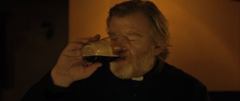 Movie still from “Calvary” (2014), directed by John Michael McDonagh – An older man drinking a glass of beer; Close Up shot, Low angle