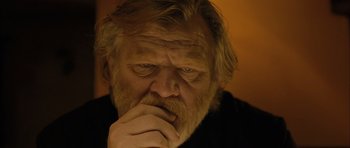 Movie still from “Calvary” (2014), directed by John Michael McDonagh – An old man with a beard is holding his hand to his face; Close Up shot, Low angle