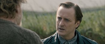 Movie still from “Calvary” (2014), directed by John Michael McDonagh – A person wearing a jacket; Close Up shot, Over the shoulder angle