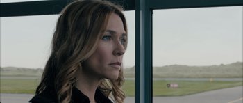 Movie still from “Calvary” (2014), directed by John Michael McDonagh – A person looking out a window; Close Up shot, Over the shoulder angle