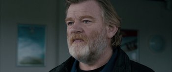 Movie still from “Calvary” (2014), directed by John Michael McDonagh – An older man with a beard looking at the camera; Close Up shot, Low angle