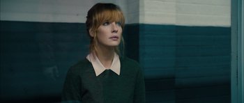 Movie still from “Calvary” (2014), directed by John Michael McDonagh – A woman in a green sweater looking up; Close Up shot, Over the shoulder angle
