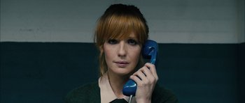 Movie still from “Calvary” (2014), directed by John Michael McDonagh – A woman holding up a phone to her ear; Close Up shot, Low angle