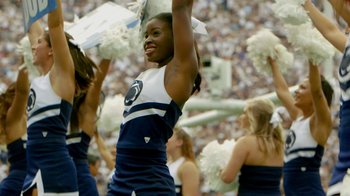 Movie still from “Cameraperson” (2016), directed by Kirsten Johnson – A woman that is cheering for the penn state team; Medium shot, Low angle