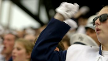 Movie still from “Cameraperson” (2016), directed by Kirsten Johnson – A person in a crowd raising their hands in the air; Extreme Close Up shot, Low angle