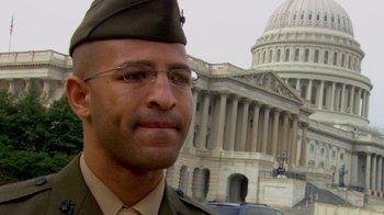 Movie still from “Cameraperson” (2016), directed by Kirsten Johnson – A man in a military uniform standing in front of the capitol building; Close Up shot, Low angle