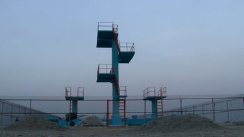 Movie still from “Cameraperson” (2016), directed by Kirsten Johnson – A group of blue and red ladders on top of a hill; Extreme Wide shot, High angle