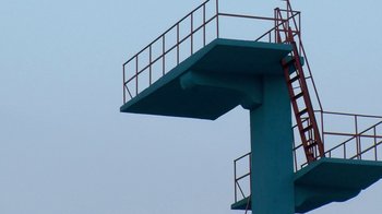 Movie still from “Cameraperson” (2016), directed by Kirsten Johnson – A diving board is shown against a blue sky background; Extreme Wide shot, Low angle