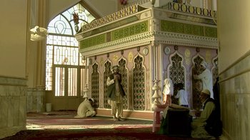 Movie still from “Cameraperson” (2016), directed by Kirsten Johnson – A man taking a picture in a mosque; Wide shot, Low angle