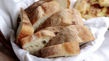 Movie still from “Cameraperson” (2016), directed by Kirsten Johnson – A piece of bread on a plate; Extreme Close Up shot, Overhead angle