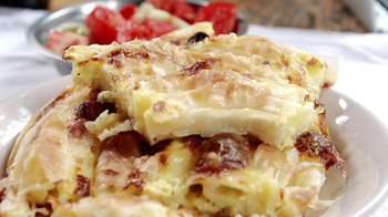 Movie still from “Cameraperson” (2016), directed by Kirsten Johnson – View of some food on a plate on a table; Extreme Close Up shot, High angle