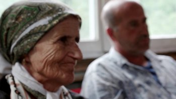 Movie still from “Cameraperson” (2016), directed by Kirsten Johnson – An old woman and a man sitting next to each other; Close Up shot, Over the shoulder angle