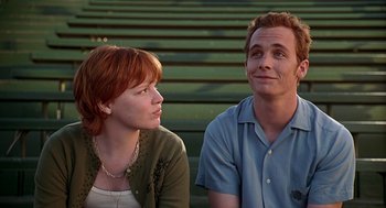 Movie still from “Can't Hardly Wait” (1998), directed by Deborah Kaplan – A man and a woman sitting next to each other; Medium shot, Low angle